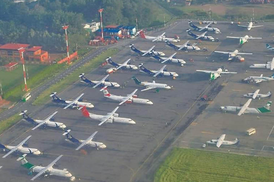 Closed Tribhuvan International Airport in Kathmandu with grounded planes as flights suspended indefinitely due to adverse circumstances.