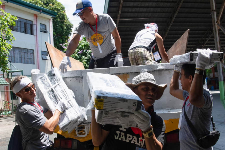 Workers unload ballots at a polling station in Manila on Sunday, on the eve of the Philippine mid-term elections widely seen as a referendum on the explosive feud between President Ferdinand Marcos and impeached vice-president Sara Duterte.