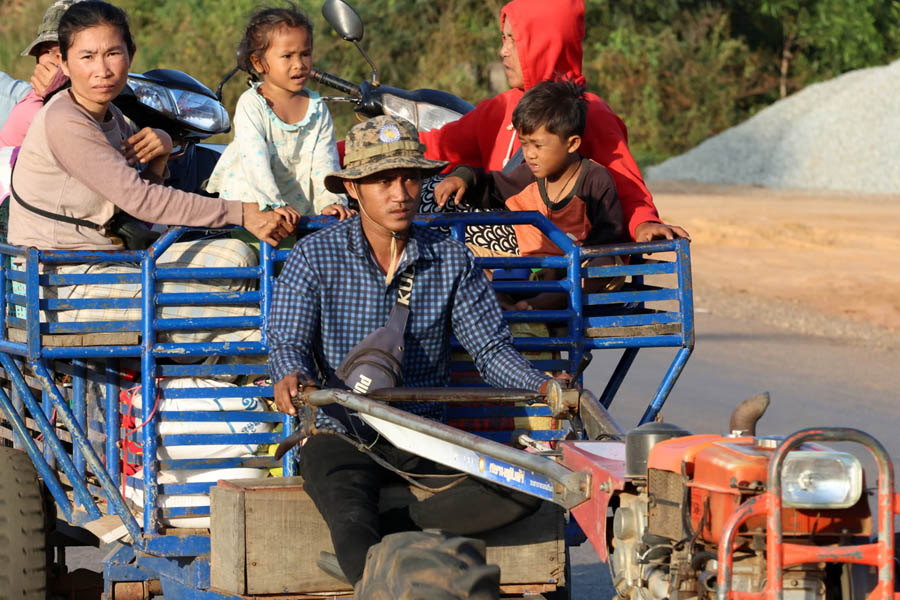 Cambodian families evacuating from border areas and arriving at a shelter in Siem Reap province for safety.
