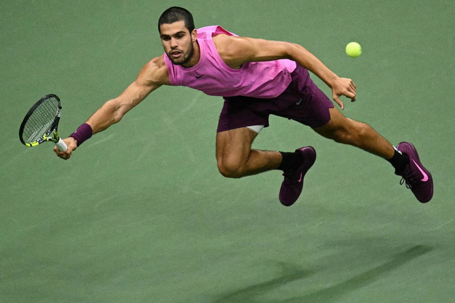 Carlos Alcaraz plays a powerful forehand return to Jannik Sinner during his four-set victory in the US Open men's singles final.