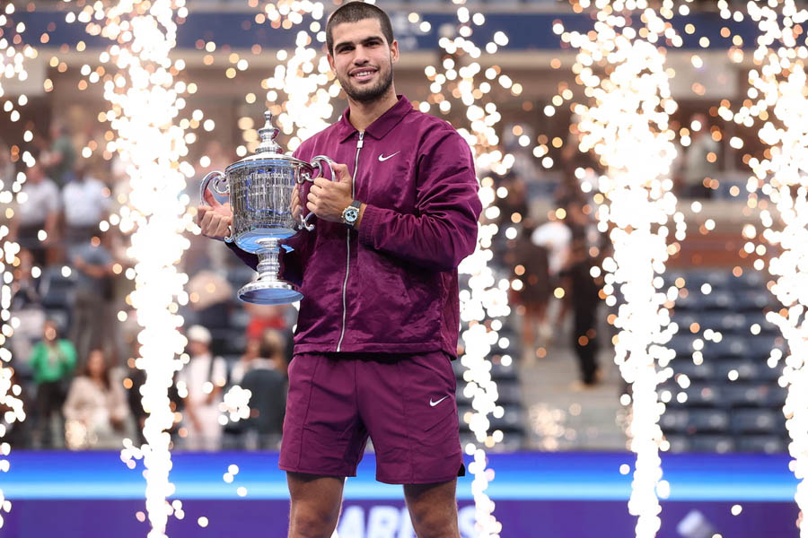 Carlos Alcaraz poses with the US Open trophy after winning the men's singles final against Jannik Sinner in New York.
