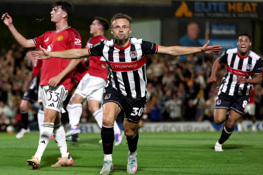 Grimsby Town striker Charles Vernam shows his delight on the pitch after scoring the opening goal against Manchester United.