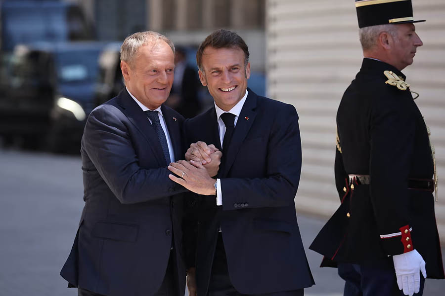 France’s President Emmanuel Macron and Poland’s prime minister Donald Tusk share a laugh as they arrive at Stanislas square in Nancy, Eastern France