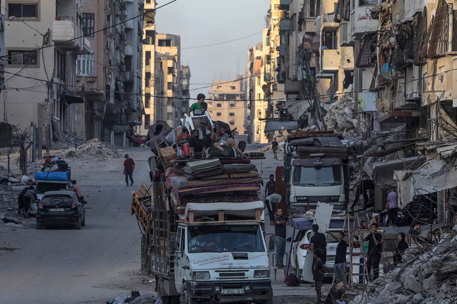 Internally displaced Palestinians evacuating a bombed area after an Israeli airstrike in Gaza City on Sunday