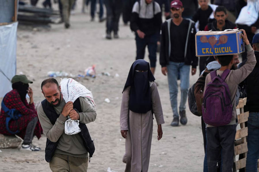Palestinians carry provisions supplied by the Gaza Humanitarian Foundation on Tuesday.