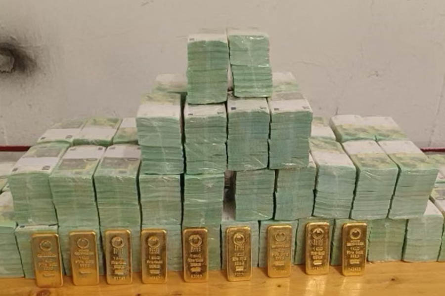 Photo released by the Hungarian government showing stacks of cash and gold bars confiscated from two armored vehicles reportedly carrying Ukrainian funds during a financial investigation in Hungary.