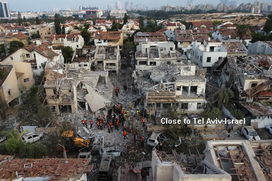 Rescue personnel work at an impact site following missile attack by Iran on Rishon LeZion, near Tel Aviv.