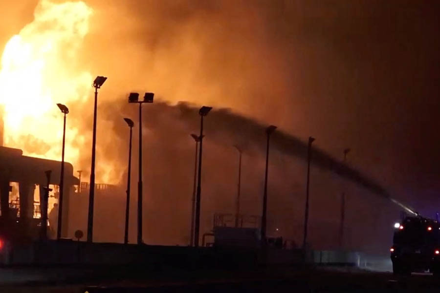 Emergency firefighters responding to a large fire at fuel tanks near Muharraq airport in Bahrain following reported Iranian strikes amid the Middle East war in March 2026.