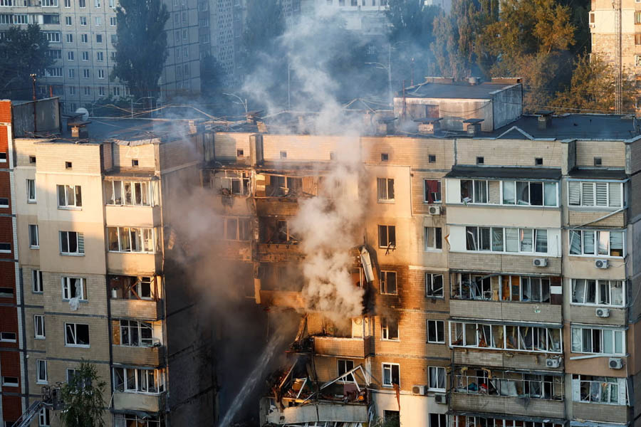 Emergency workers extinguish a fire in a Kyiv apartment building on Sunday following Russia’s air attack.