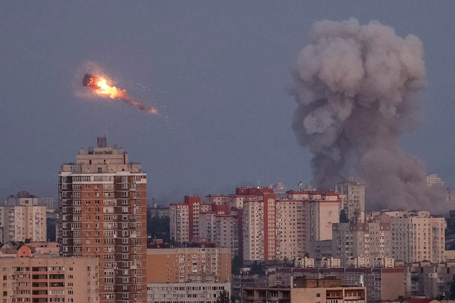 Explosion in the sky over Kyiv as Ukrainian defences shoot down an incoming Russian target and smoke rises from a previous strike.