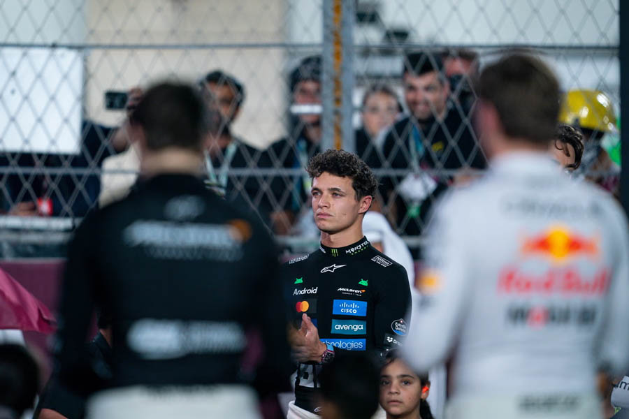 Lando Norris standing confidently as he prepares for the Abu Dhabi finale, where a top-three finish would secure his Formula One world title.