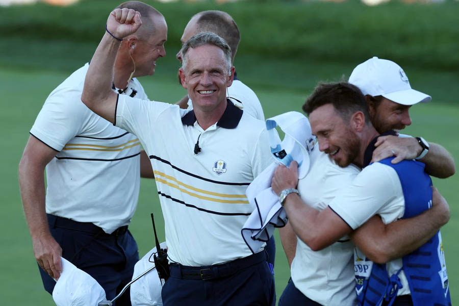 Luke Donald, captain of Team Europe, celebrates as Tyrrell Hatton secures a half point on the 18th hole in the singles, clinching Ryder Cup victory.
