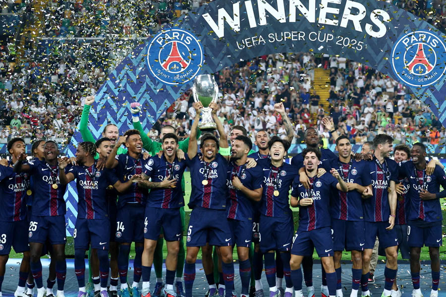 PSG captain Marquinhos celebrates by lifting the UEFA Super Cup trophy after a dramatic penalty shootout victory.