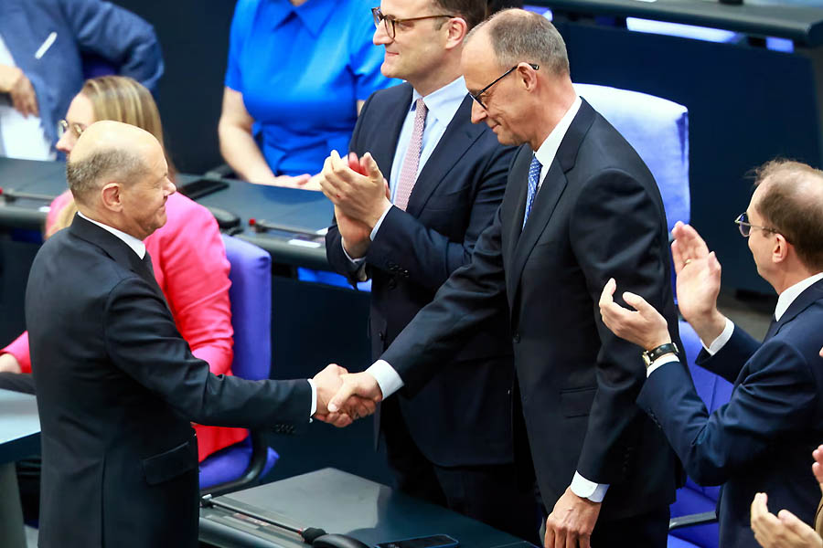 Olaf Scholz congratulates newly elected Chancellor Friedrich Merz after the second round of voting at the Bundestag in Berlin, Germany.