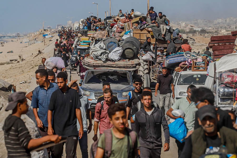 Palestinian civilians carrying belongings flee Gaza City on 16 September during an Israeli ground offensive.