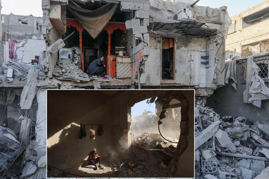 Palestinians walk through rubble of destroyed homes following an Israeli airstrike in Khan Yunis, Gaza, May 3.