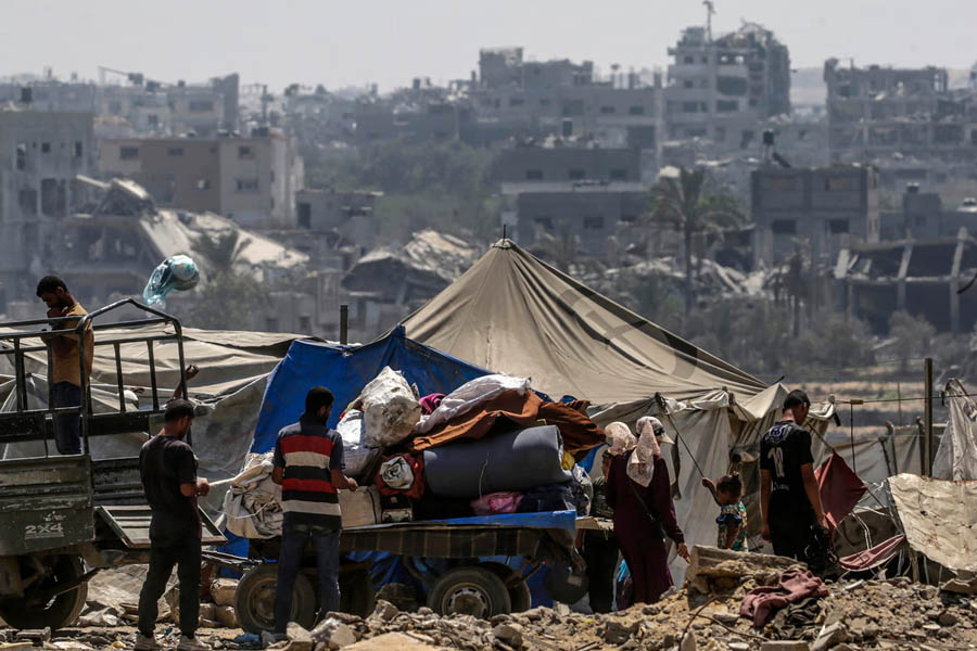 Palestinians gather in the Sheikh Radwan neighbourhood of Gaza City during Israeli airstrikes on Saturday.