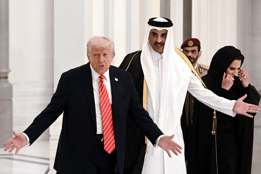 Qatar's emir Sheikh Tamim bin Hamad al-Thani greets Donald Trump in Doha on 14 May 2025.