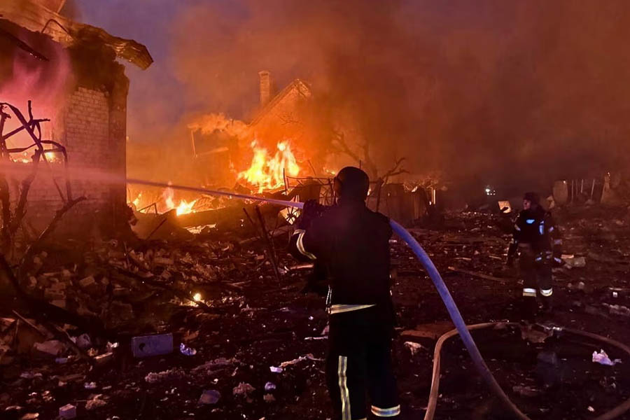 Ukrainian firefighters at work after a massive Russian missile and drone attack on Kyiv.