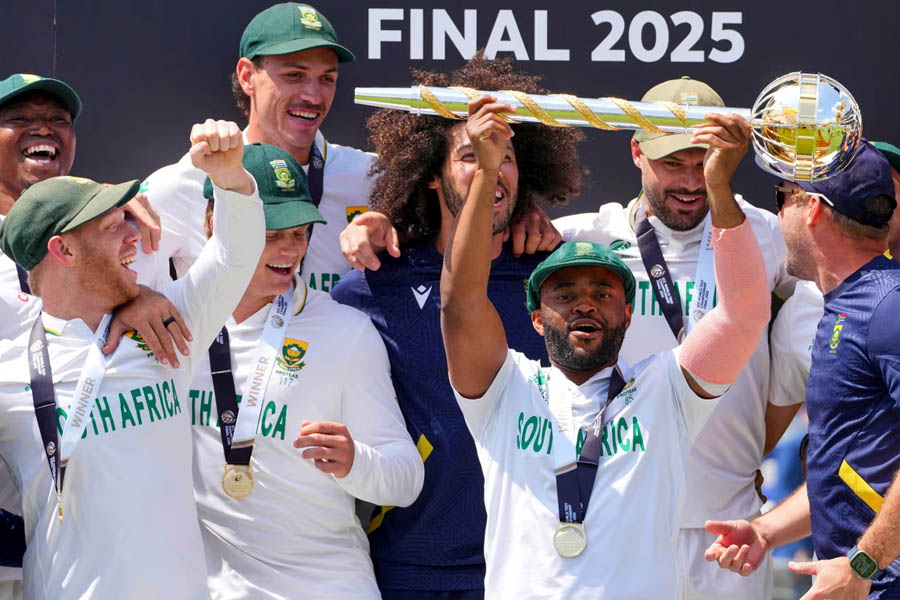 South Africa's captain Temba Bavuma holds up the World Test Championship winner’s mace among his celebrating teammates.