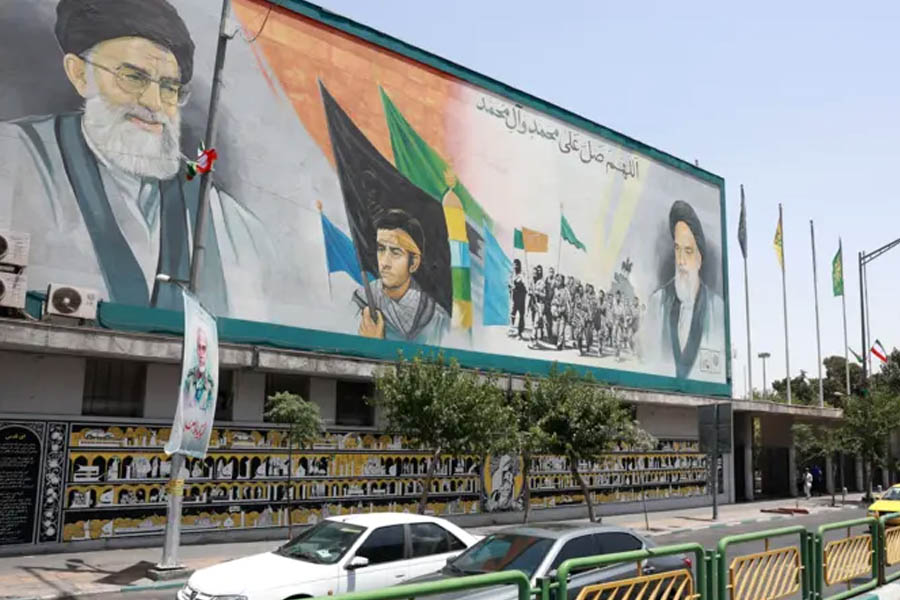 Cars in Tehran cruise past towering posters of Iran’s Supreme Leader Ayatollah Khamenei and former leader Ayatollah Khomeini, showcasing the enduring presence of the Islamic Republic’s legacy.