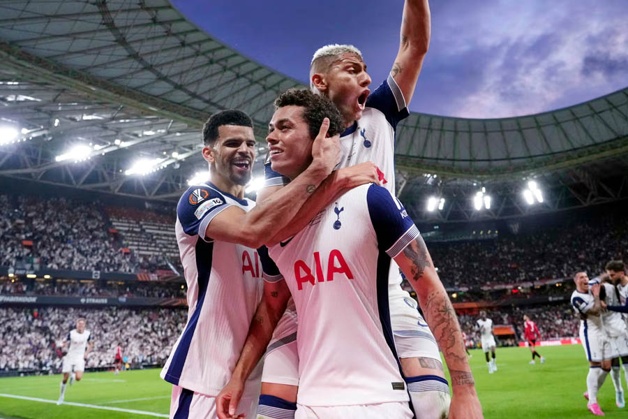 Tottenham's Brennan Johnson is congratulated by Dominic Solanke and Richarlison after scoring the only goal against Manchester United.