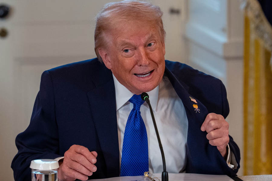 Donald Trump wearing a “Happy Trump” lapel pin as he meets with oil company executives in the White House East Room during talks on Venezuela.