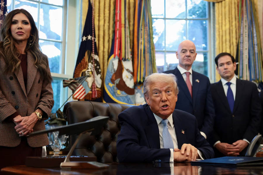 Donald Trump with Kristi Noem, Marco Rubio, and FIFA president Gianni Infantino at the White House discussing the 2026 World Cup visa system.