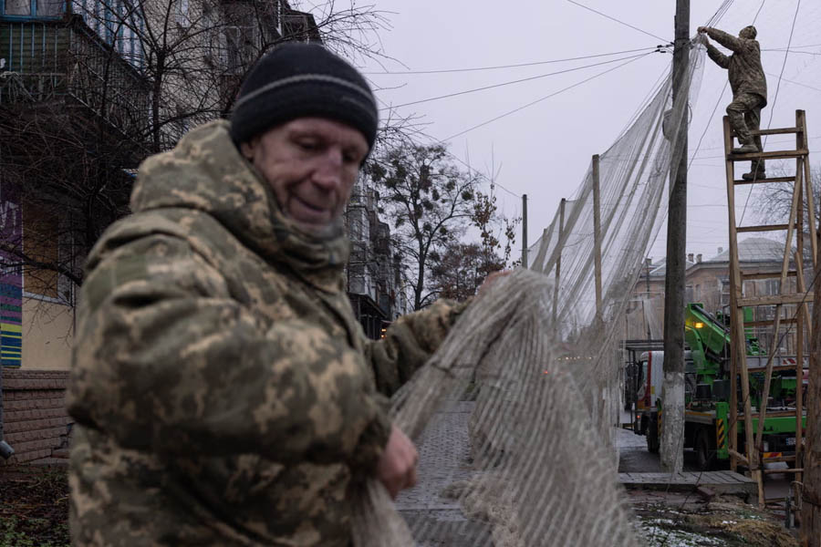 Ukrainian soldiers installing anti-drone nets in the city centre of Izyum in the Kharkiv region, roughly 25km west of the frontline.