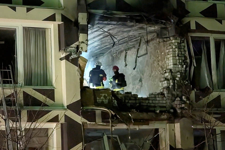 Ukrainian rescue workers operating at the site of a Russian drone attack on a private hospital in Kyiv, searching for survivors under the rubble.