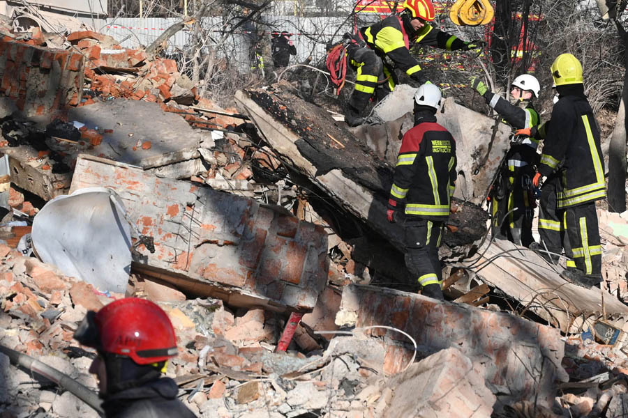 Rescue workers searching through debris at a destroyed residential building in Ternopil, Ukraine, after a deadly Russian air strike that left at least 26 people dead.