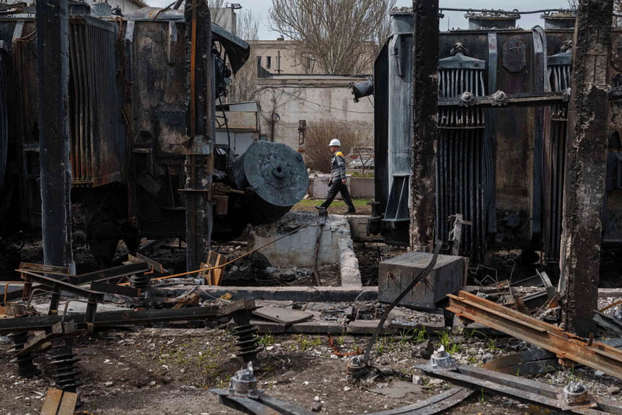Destroyed Ukrainian substation following a Russian drone strike, with smoke rising from damaged power lines and debris scattered across the site.