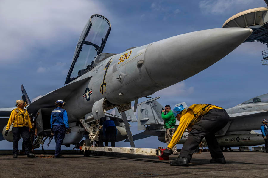 U.S. Navy sailors preparing a Boeing EA-18G Growler aircraft on the flight deck of USS Abraham Lincoln aircraft carrier amid Middle East military deployment
