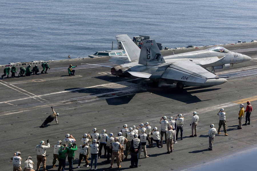 U.S. Navy F/A-18 Super Hornet taking off from the flight deck of the USS Abraham Lincoln in the Arabian Sea during heightened military deployments near Iran in 2026.