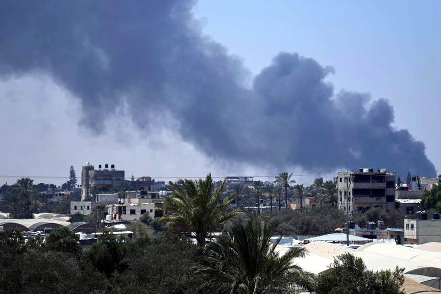 Smoke rises from the WHO staff compound in Deir al-Balah after reported Israeli strikes hit residential quarters and the main warehouse during intensified military operations in Gaza.